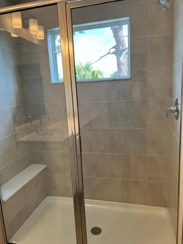 a bathroom with a glass shower door