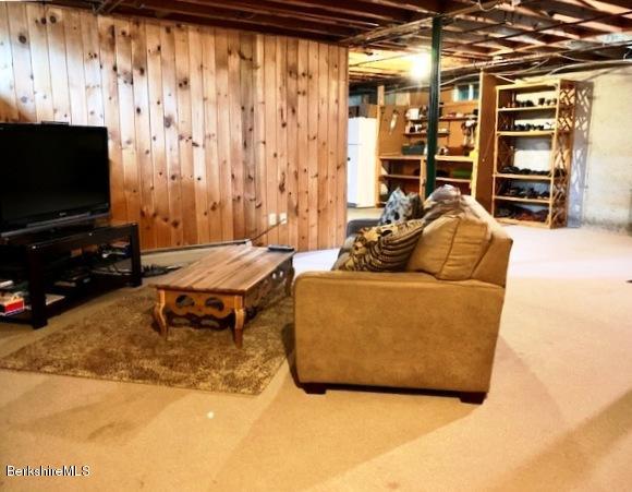 11 Woodruff Road West Stockbridge, MA 01266 - Photo 22 of 27 a living room with furniture a flat screen tv and a floor to ceiling window