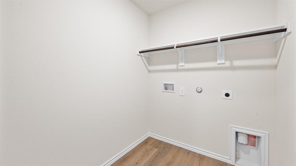 225 Pheasant Run Road Terrell, TX 75160 - Photo 33 of 34 Wood-finish flooring, overhead shelving, and a hanging rod