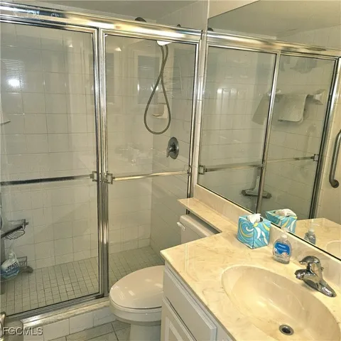 a bathroom with a sink shower and a mirror