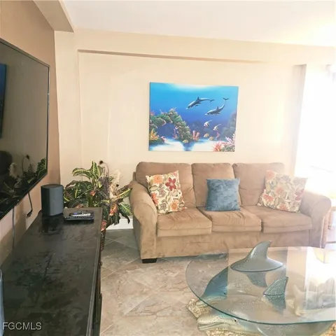 a living room with furniture and a painting