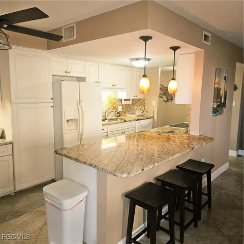 a kitchen with a table and chairs