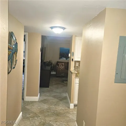 a view of a hallway with bathroom and wooden floor