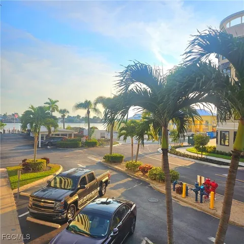 a view of a swimming pool with a lounge chair and tables