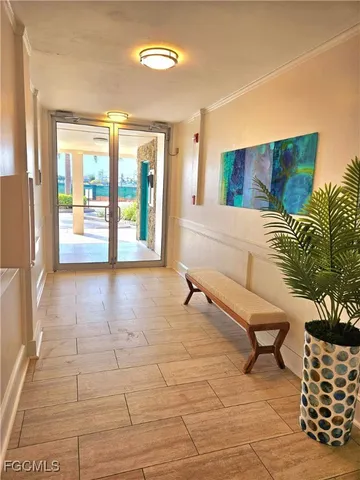 a view of an entryway with wooden floor and door