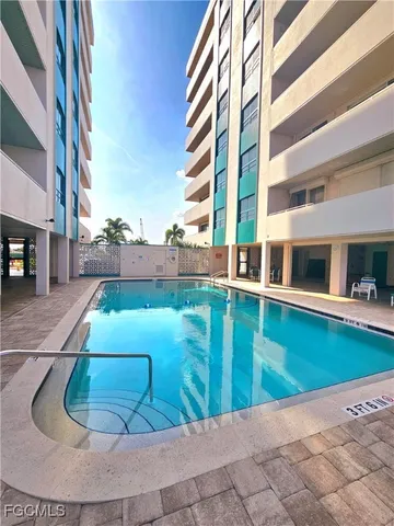 a view of a swimming pool with a yard