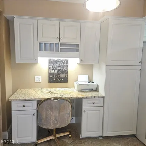 a kitchen with granite countertop cabinets sink and stove