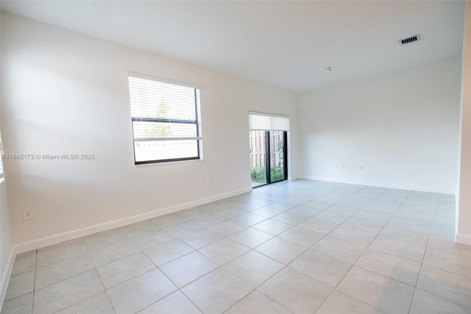 24720 Southwest 119th Place, Unit 24720 Homestead, FL 33032 - Photo 15 of 30 an empty room with windows