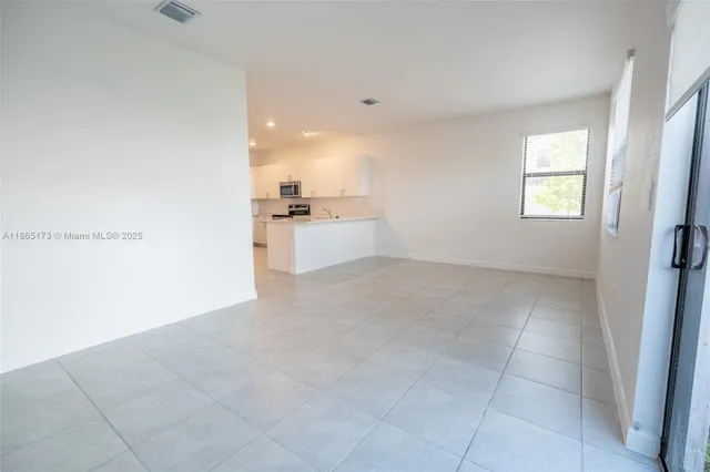 a view of a kitchen with a dishwasher and a refrigerator