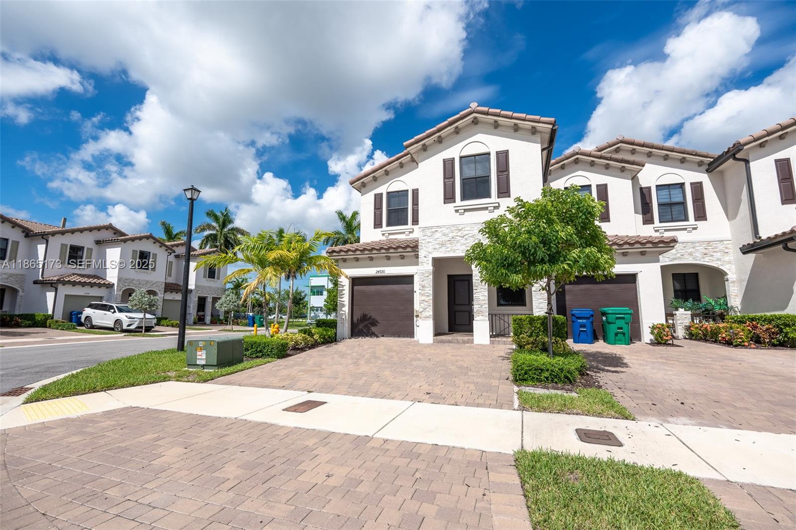 24720 Southwest 119th Place, Unit 24720 Homestead, FL 33032 - Photo 2 of 30 a front view of a house with a garden