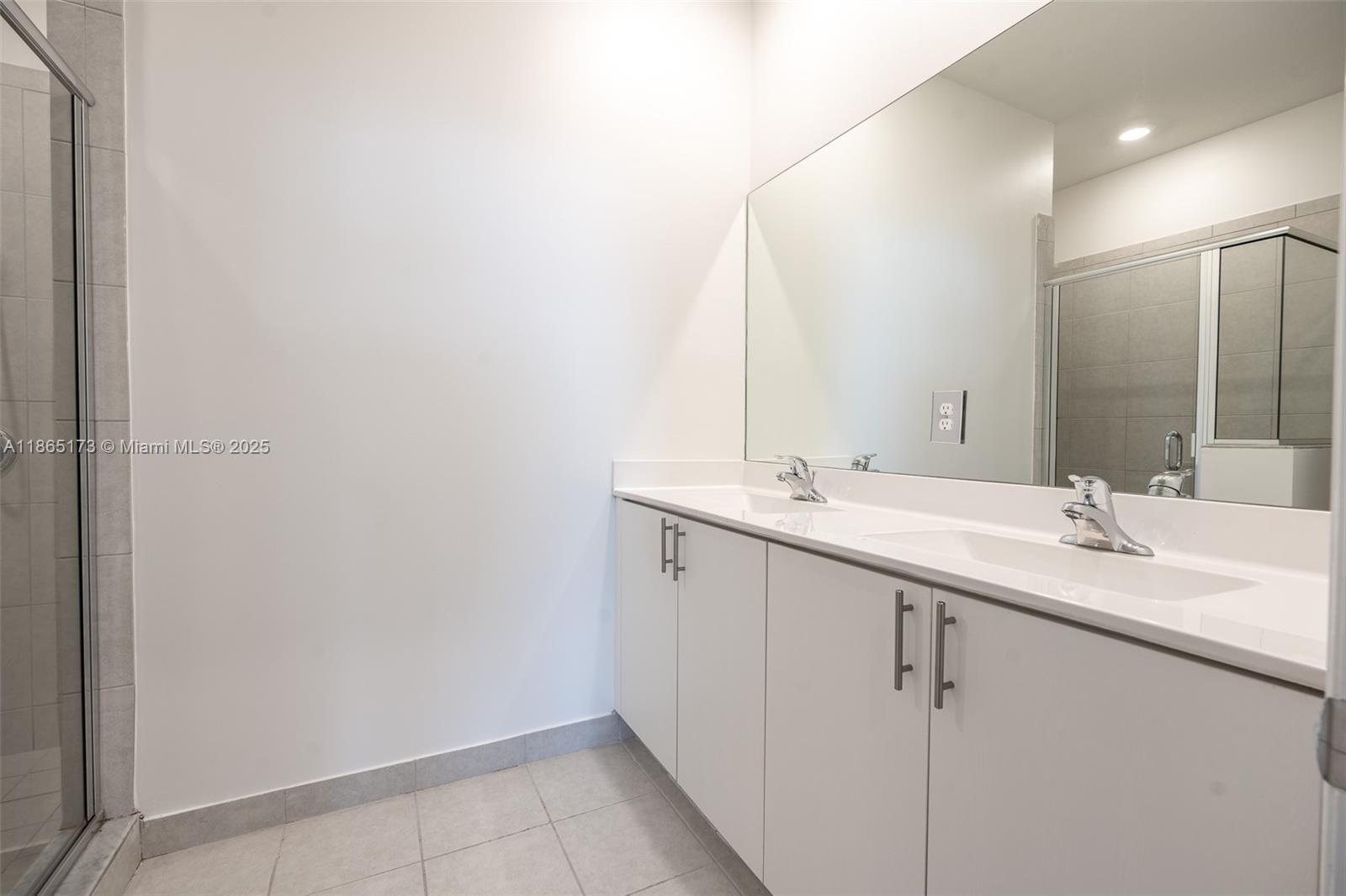 24720 Southwest 119th Place, Unit 24720 Homestead, FL 33032 - Photo 22 of 30 a bathroom with a double vanity sink and a mirror