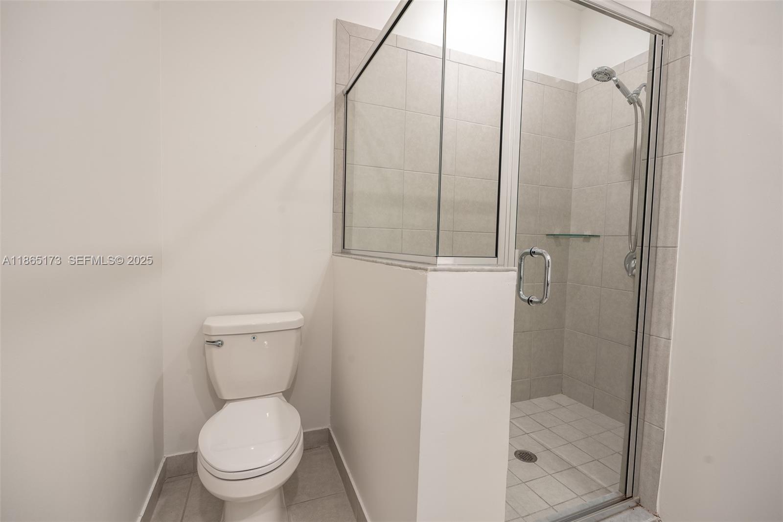 24720 Southwest 119th Place, Unit 24720 Homestead, FL 33032 - Photo 23 of 30 a bathroom with a toilet and a shower