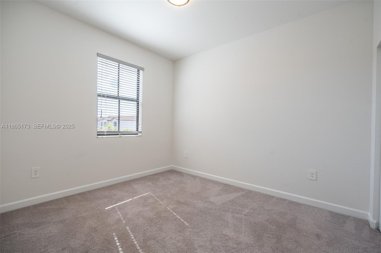 24720 Southwest 119th Place, Unit 24720 Homestead, FL 33032 - Photo 24 of 30 an empty room with a window