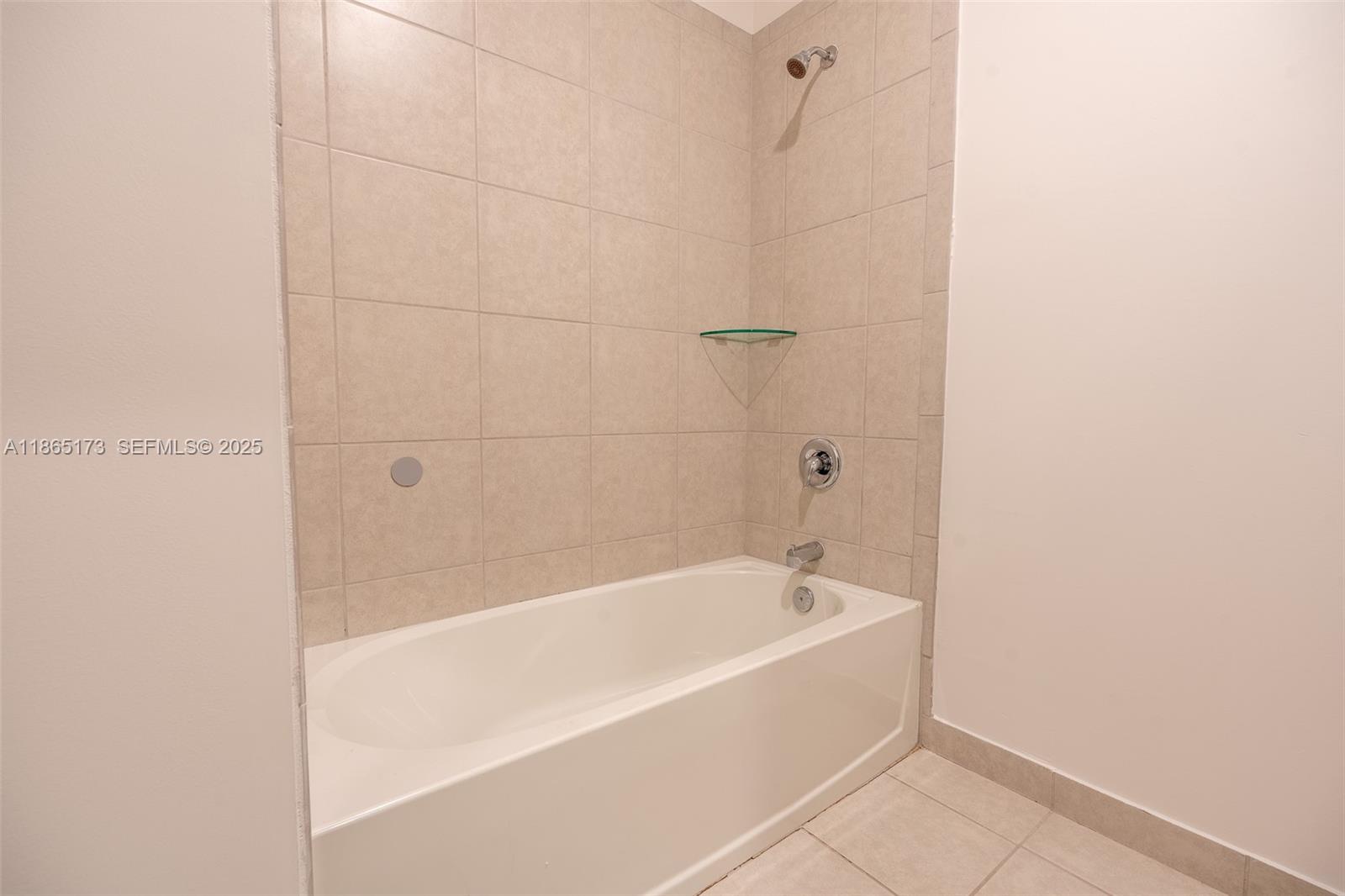 24720 Southwest 119th Place, Unit 24720 Homestead, FL 33032 - Photo 29 of 30 a white bath tub sitting next to a white wall