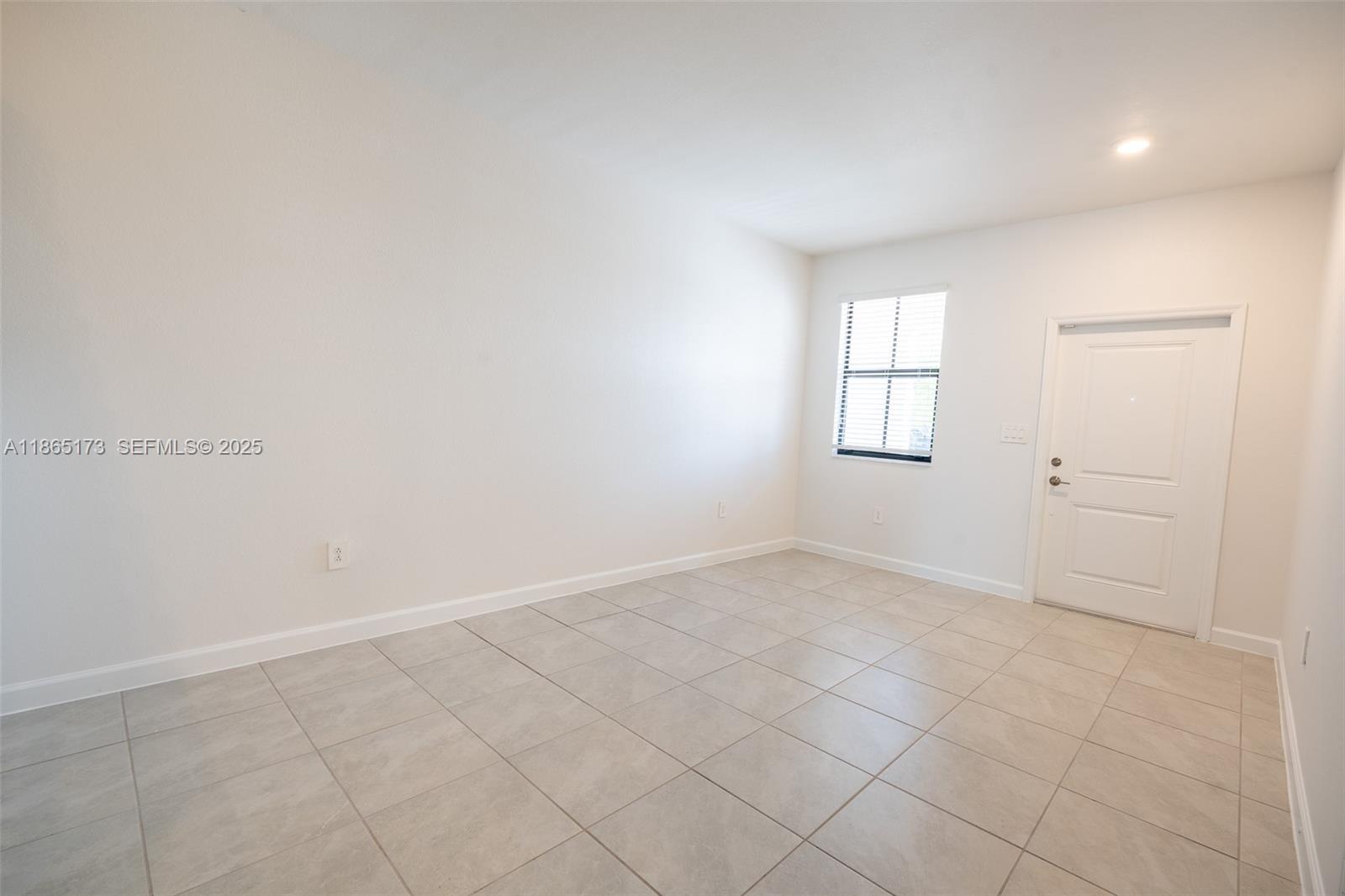 24720 Southwest 119th Place, Unit 24720 Homestead, FL 33032 - Photo 9 of 30 an empty room with windows