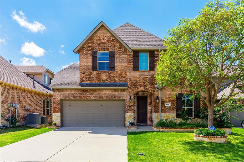 1 / 33Traditional home featuring a shingled roof, brick siding, a front yard, and driveway