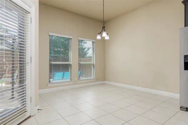an empty room with windows and outdoor view