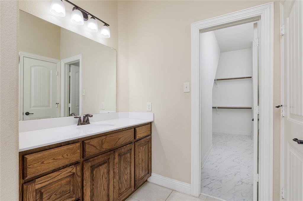 404 Tanner Square McKinney, TX 75072 - Photo 19 of 34 Bathroom with vanity, baseboards, and marble finish floors