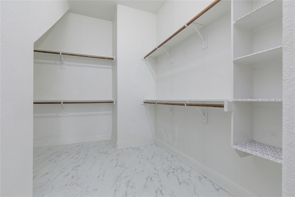 404 Tanner Square McKinney, TX 75072 - Photo 20 of 34 Walk in closet featuring marble look tile flooring