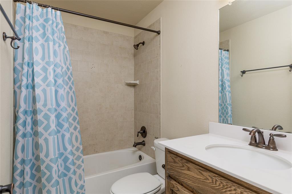 404 Tanner Square McKinney, TX 75072 - Photo 25 of 34 Full bath featuring vanity, toilet, and shower / tub combo with curtain