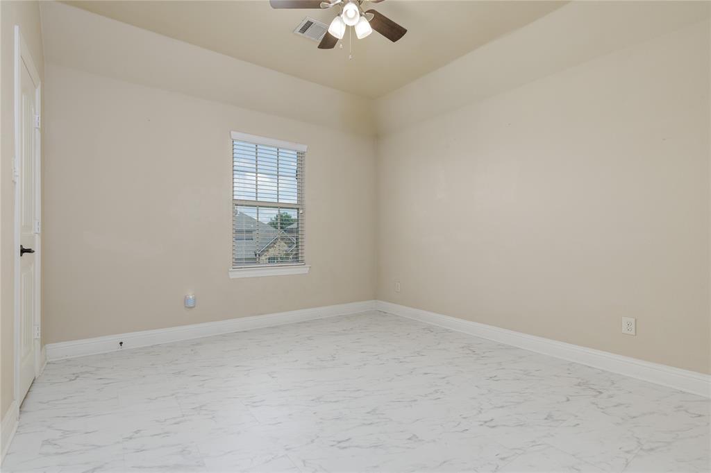 404 Tanner Square McKinney, TX 75072 - Photo 26 of 34 Empty room featuring light marble finish flooring, ceiling fan, and baseboards