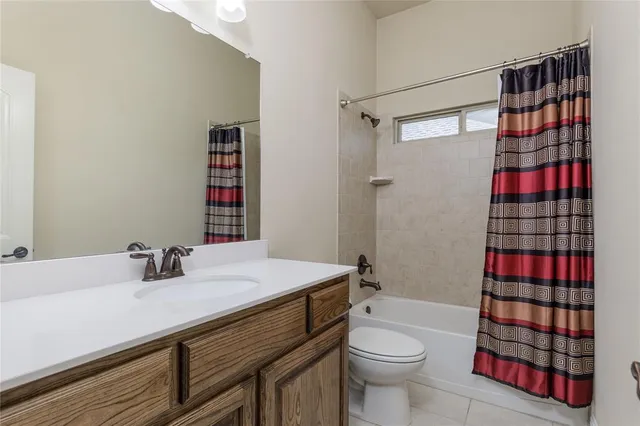 a bathroom with a sink toilet vanity and shower