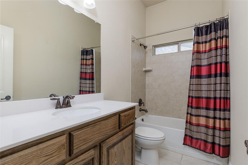 404 Tanner Square McKinney, TX 75072 - Photo 27 of 34 Bathroom featuring tile patterned floors, vanity, shower / bath combo, and toilet