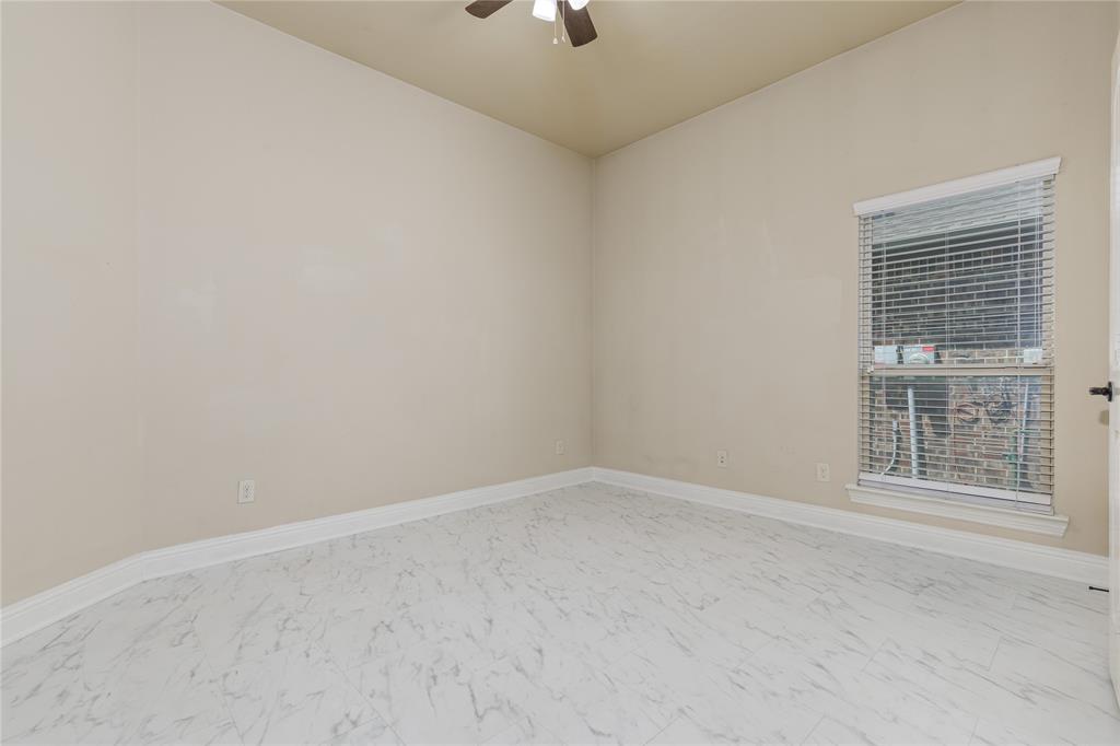 404 Tanner Square McKinney, TX 75072 - Photo 28 of 34 Empty room featuring marble look tile flooring, ceiling fan, and baseboards