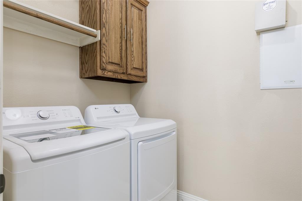 404 Tanner Square McKinney, TX 75072 - Photo 30 of 34 Laundry area with washer and clothes dryer and cabinet space