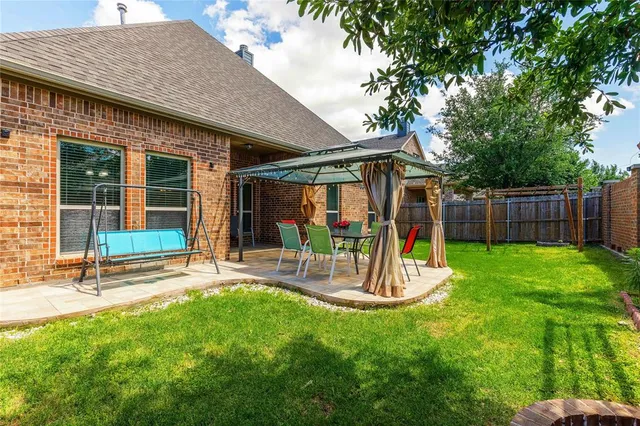 a view of a house with a yard patio and slide