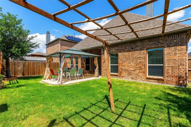 a view of a house with a yard and sitting area