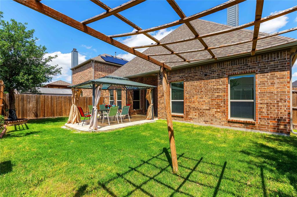 404 Tanner Square McKinney, TX 75072 - Photo 33 of 34 Rear view of house featuring brick siding, a pergola, a chimney, and a gazebo