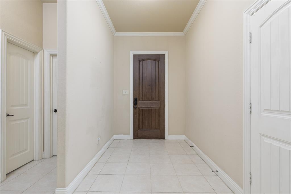 404 Tanner Square McKinney, TX 75072 - Photo 4 of 34 Entryway featuring ornamental molding and light tile patterned floors