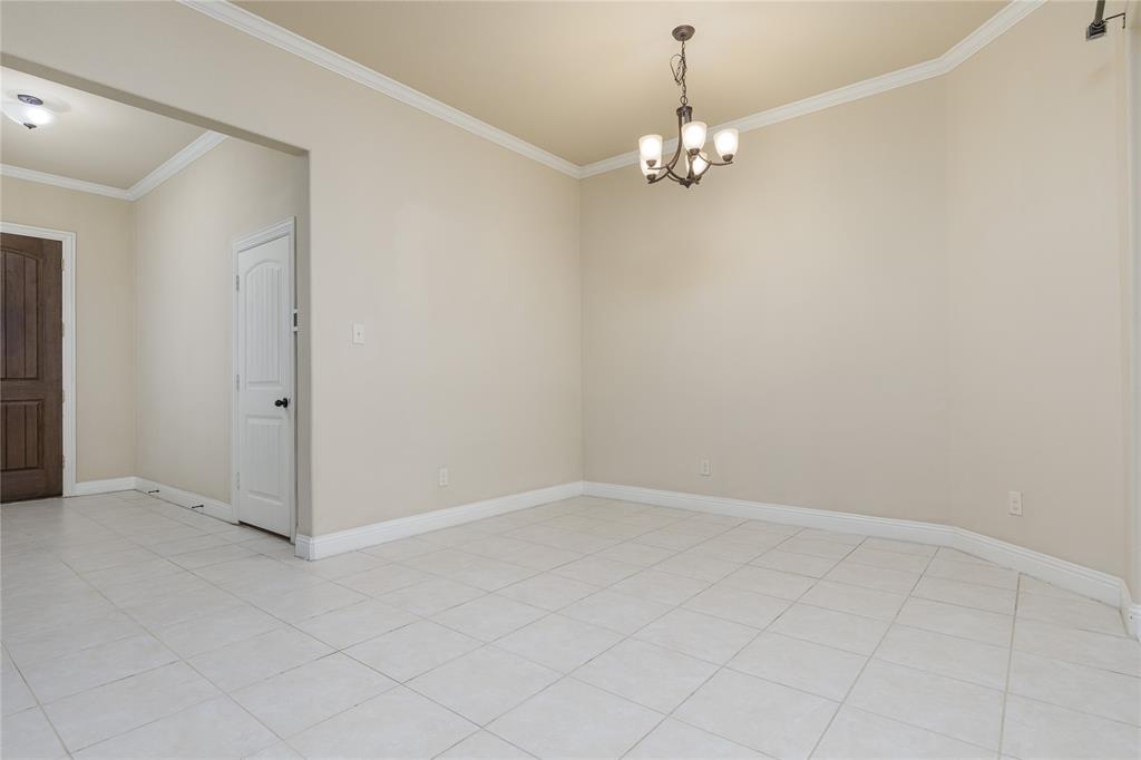 404 Tanner Square McKinney, TX 75072 - Photo 6 of 34 Spare room with ornamental molding, a chandelier, and baseboards