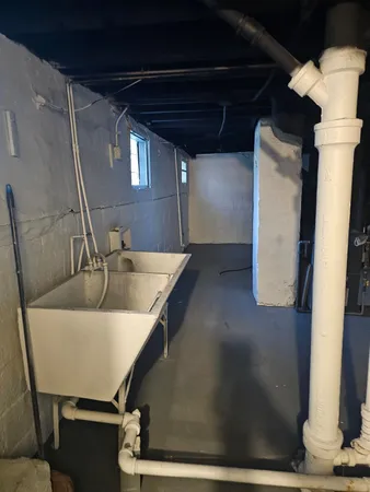 a view of kitchen with granite countertop sink
