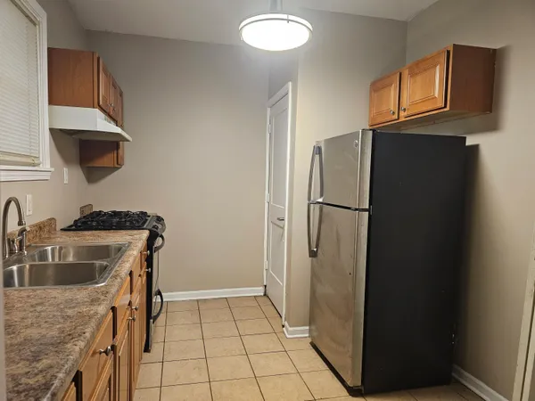 a kitchen with a refrigerator and a sink