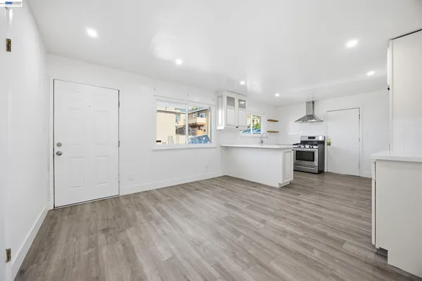 a view of a kitchen with wooden floor and electronic appliances