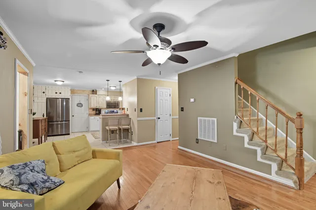 a living room with furniture and kitchen view