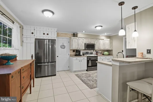 a kitchen with cabinets and stainless steel appliances