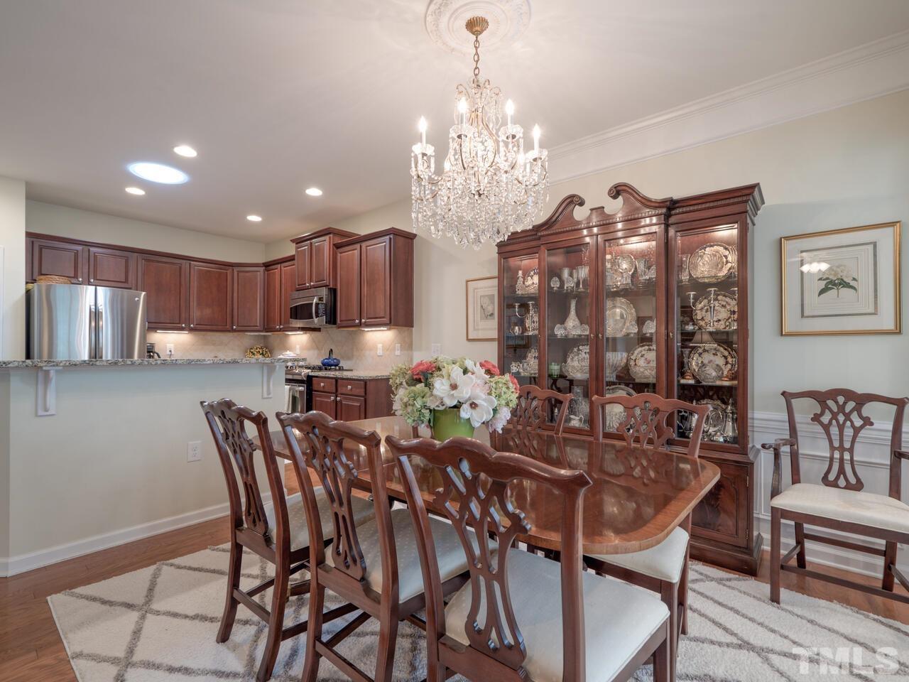 724 Eldridge Loop Cary, NC 27519 - Photo 13 of 38 a view of a dining room with furniture and chandelier