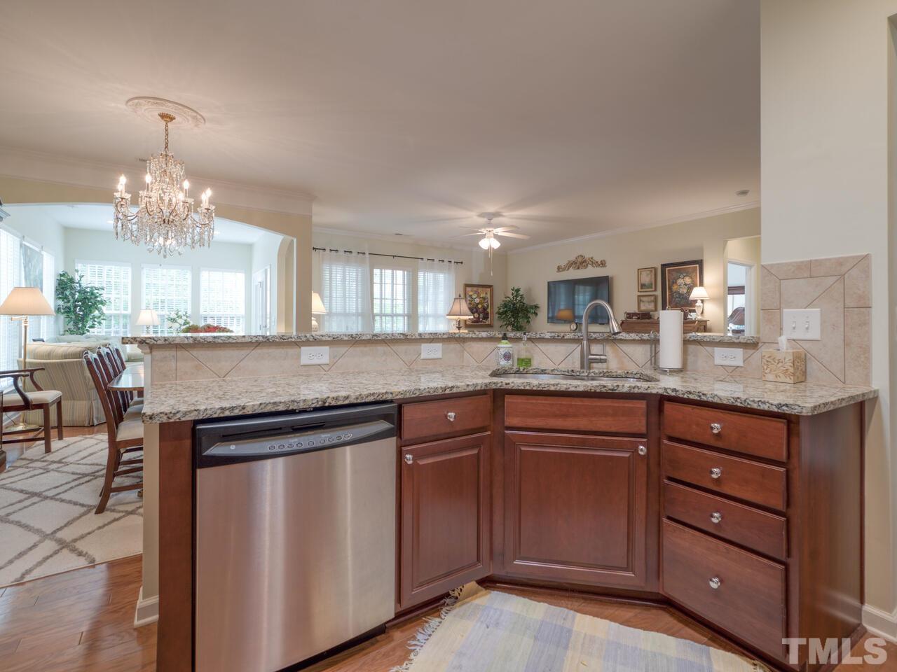724 Eldridge Loop Cary, NC 27519 - Photo 15 of 38 a kitchen with a sink and chandelier