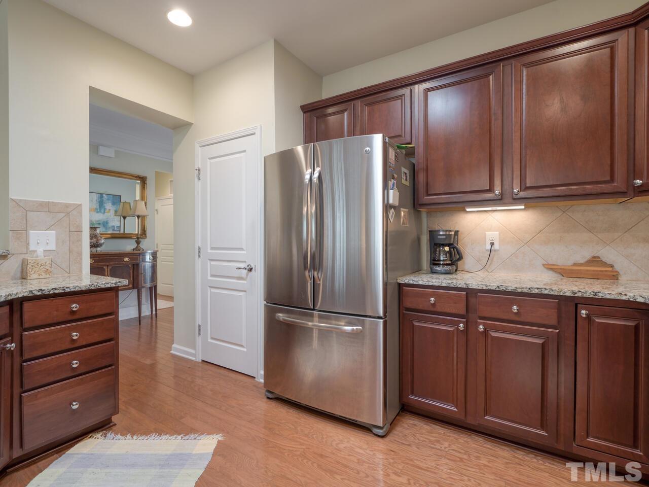 724 Eldridge Loop Cary, NC 27519 - Photo 18 of 38 a kitchen with granite countertop stainless steel appliances and refrigerator