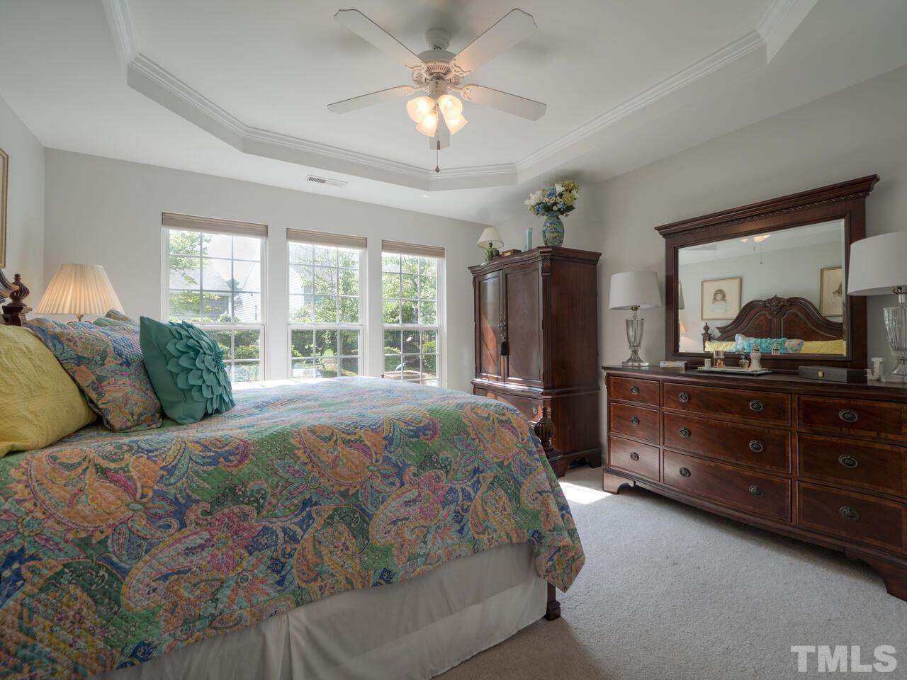 724 Eldridge Loop Cary, NC 27519 - Photo 19 of 38 a bedroom with a large bed and a large dresser