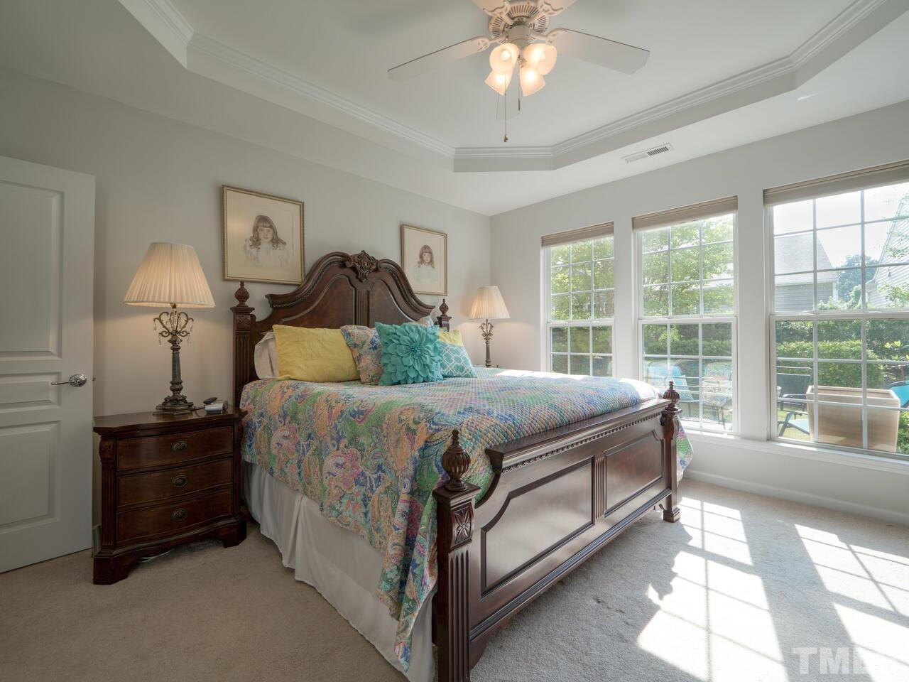 724 Eldridge Loop Cary, NC 27519 - Photo 20 of 38 a spacious bedroom with a bed and a large window
