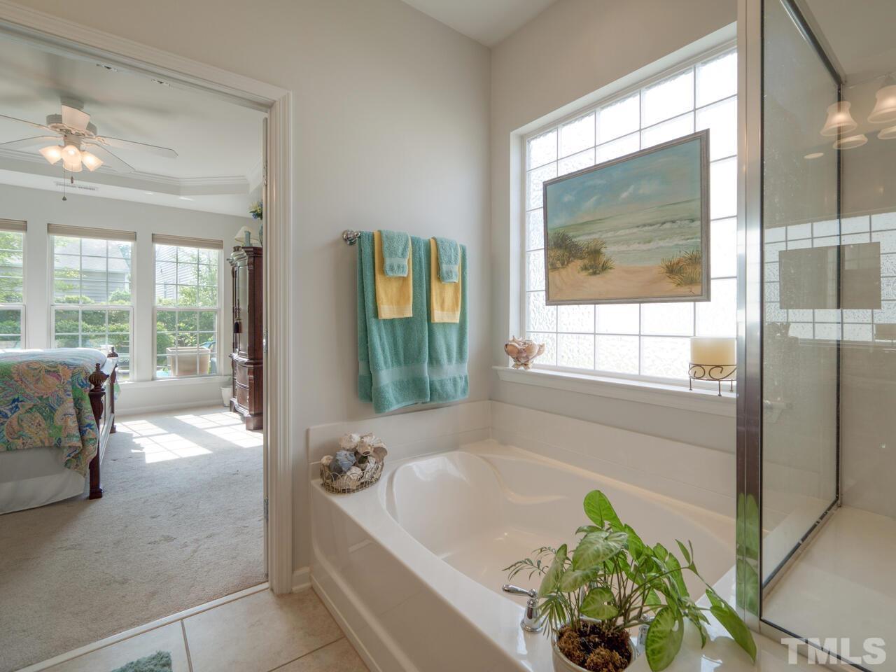 724 Eldridge Loop Cary, NC 27519 - Photo 27 of 38 a bath tub sitting in a bathroom next to a window