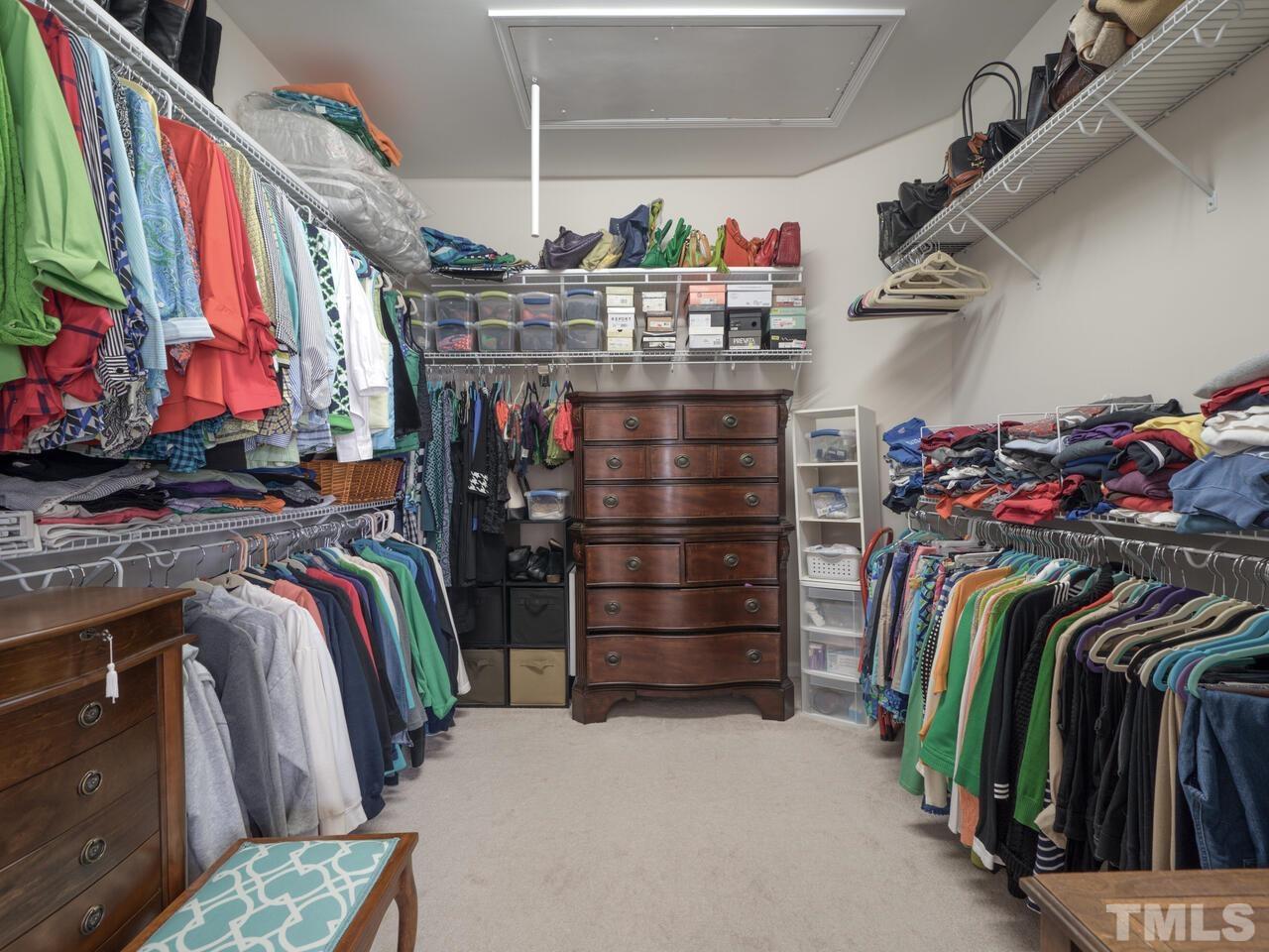 724 Eldridge Loop Cary, NC 27519 - Photo 28 of 38 a view of walk in closet with clothes and shoes