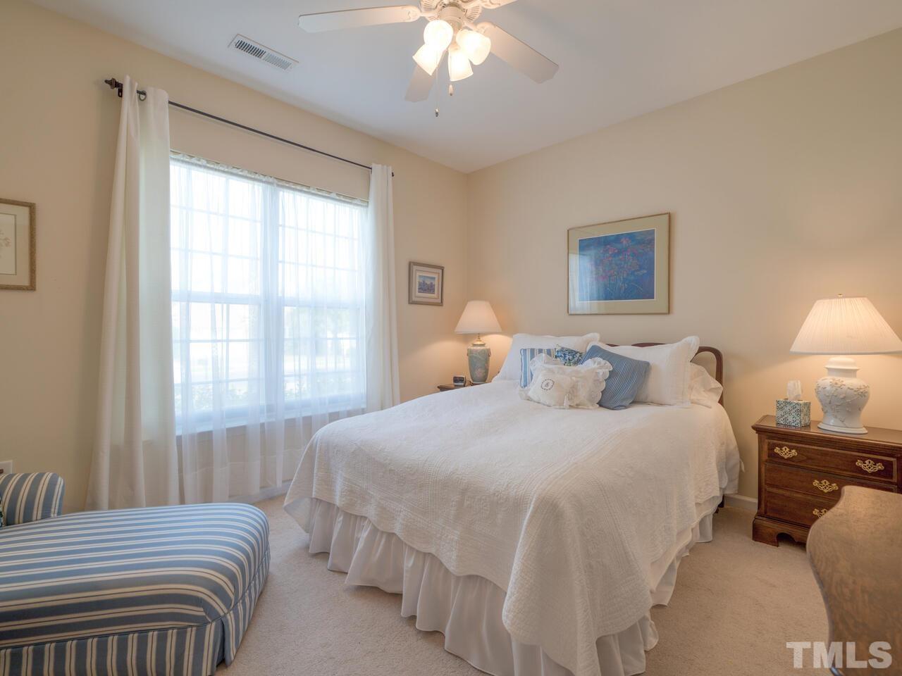 724 Eldridge Loop Cary, NC 27519 - Photo 29 of 38 a bedroom with a bed and a chandelier
