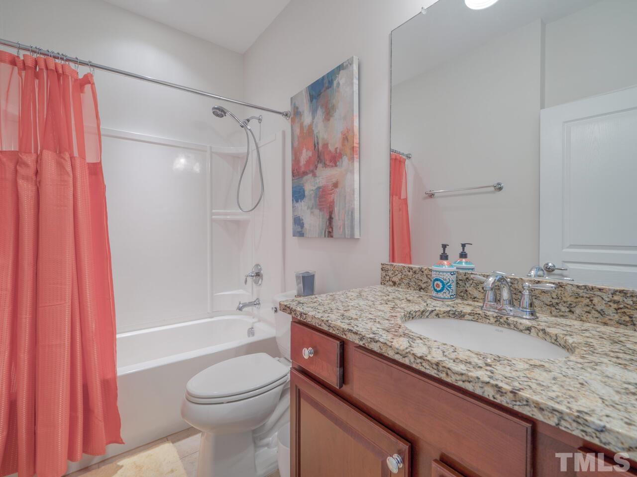724 Eldridge Loop Cary, NC 27519 - Photo 31 of 38 a bathroom with a granite countertop sink toilet and shower
