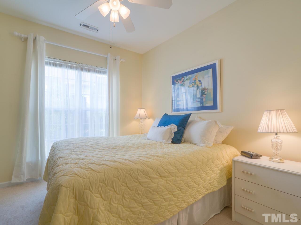 724 Eldridge Loop Cary, NC 27519 - Photo 33 of 38 a large bed sitting in a bedroom next to a lamp