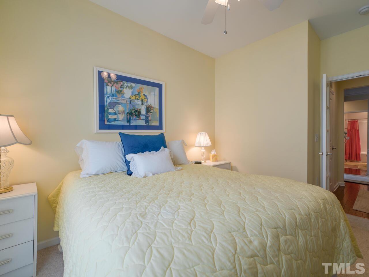 724 Eldridge Loop Cary, NC 27519 - Photo 34 of 38 a bedroom with a bed and a painting on the wall